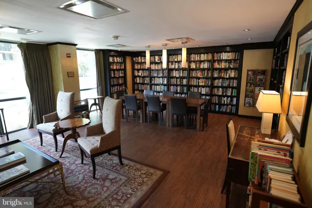 a living room with furniture a rug and a large window