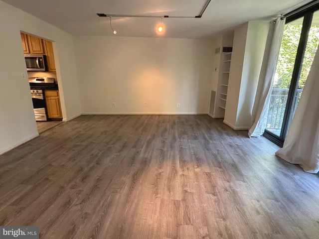 wooden floor in an empty room with a window