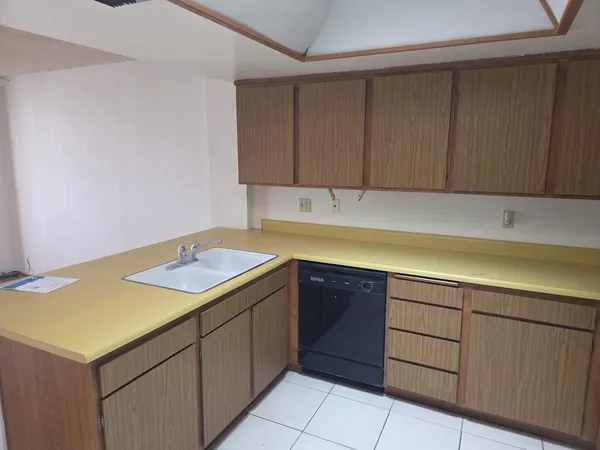 a kitchen with a sink and cabinets