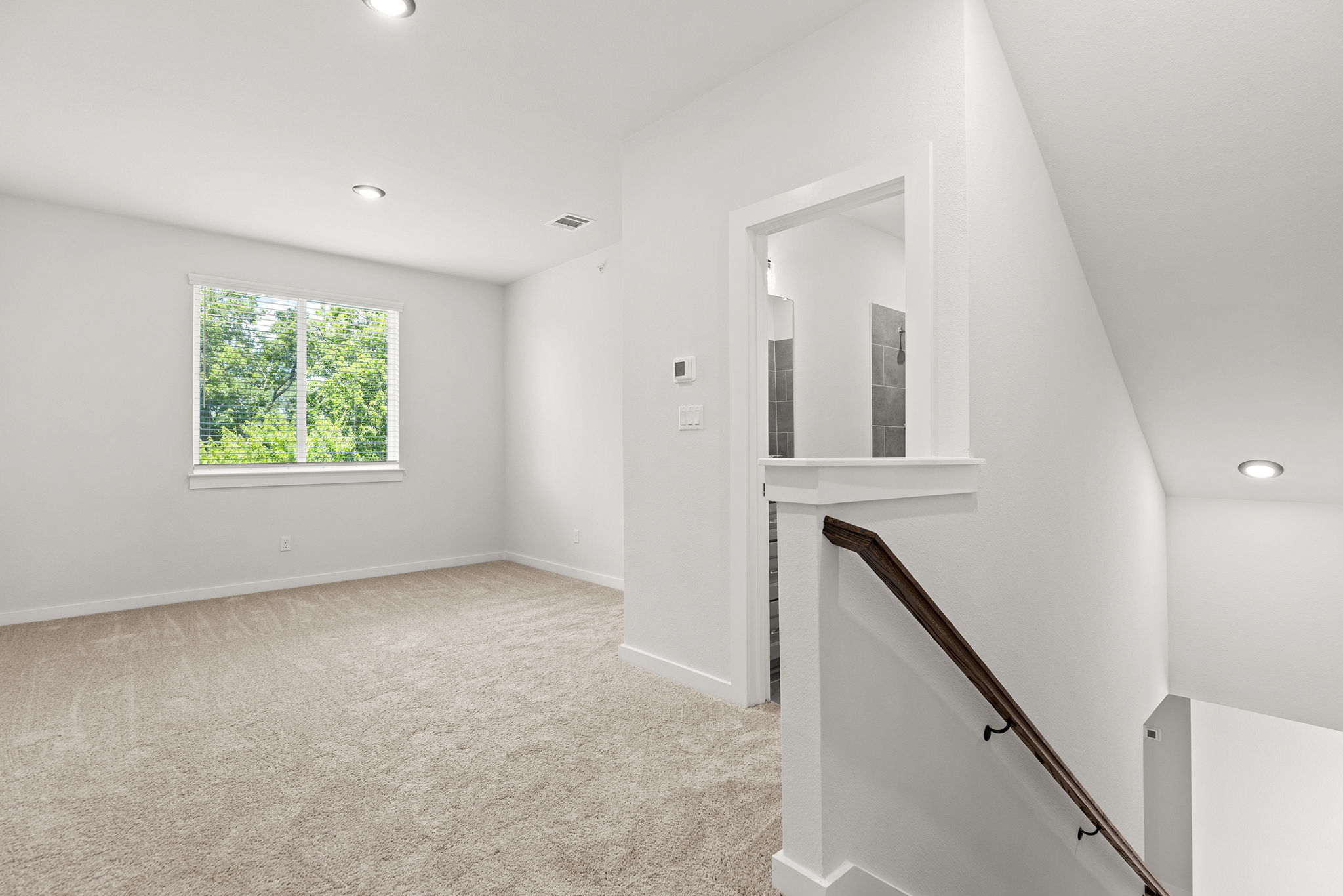 2600 Gattis School Road, Unit 1001 Round Rock, TX 78664 - Photo 23 of 40 A well-lit upper-level room with soft carpeting and ample natural illumination.