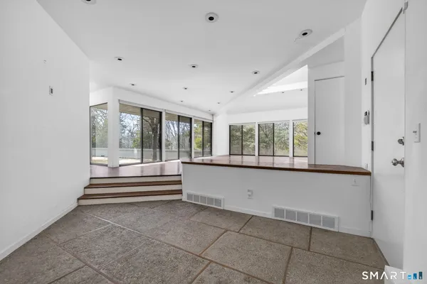 a living room with furniture and large windows