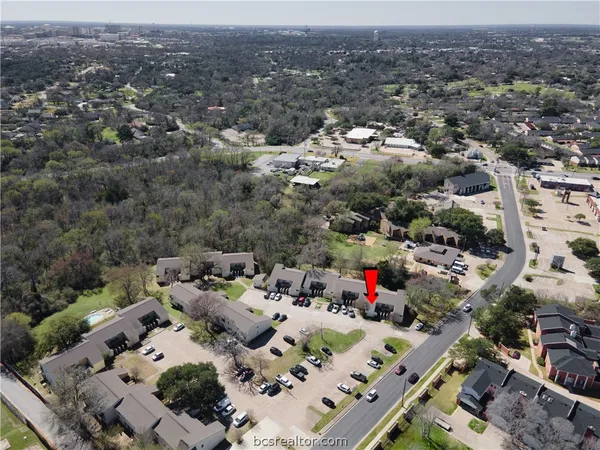 an aerial view of residential houses with outdoor space