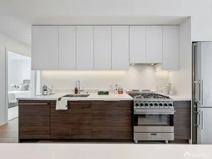 a kitchen with granite countertop a sink stainless steel appliances and cabinets