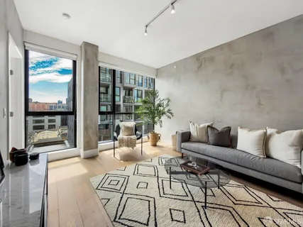 a living room with furniture and a floor to ceiling window