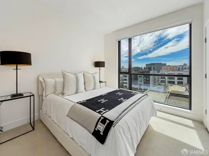 a living room with furniture and a floor to ceiling window
