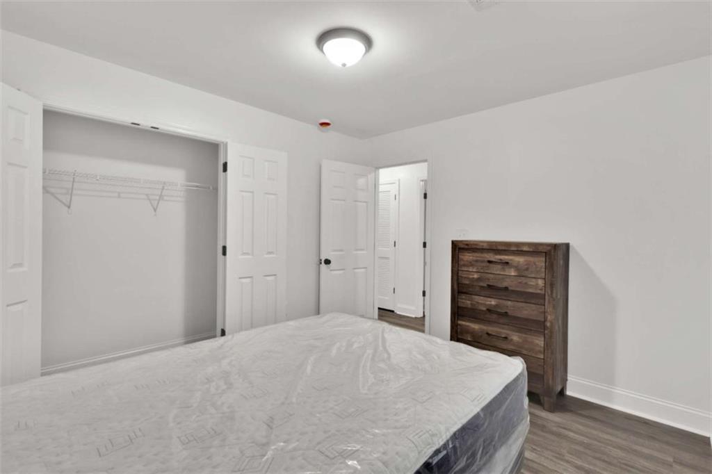 612 Elberta Street Fort Valley, GA 31030 - Photo 12 of 31 a bedroom with a bed and a dresser