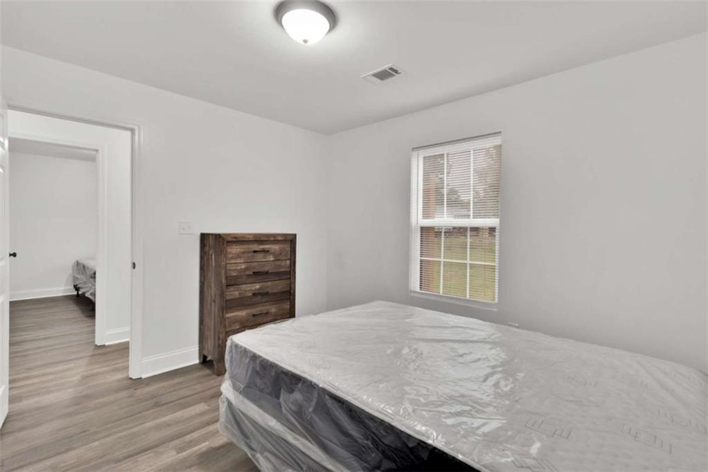 612 Elberta Street Fort Valley, GA 31030 - Photo 15 of 31 a bedroom with a bed and a dresser