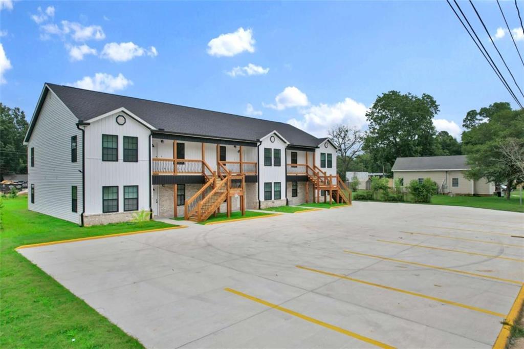 612 Elberta Street Fort Valley, GA 31030 - Photo 2 of 31 a front view of a house with a yard and garage