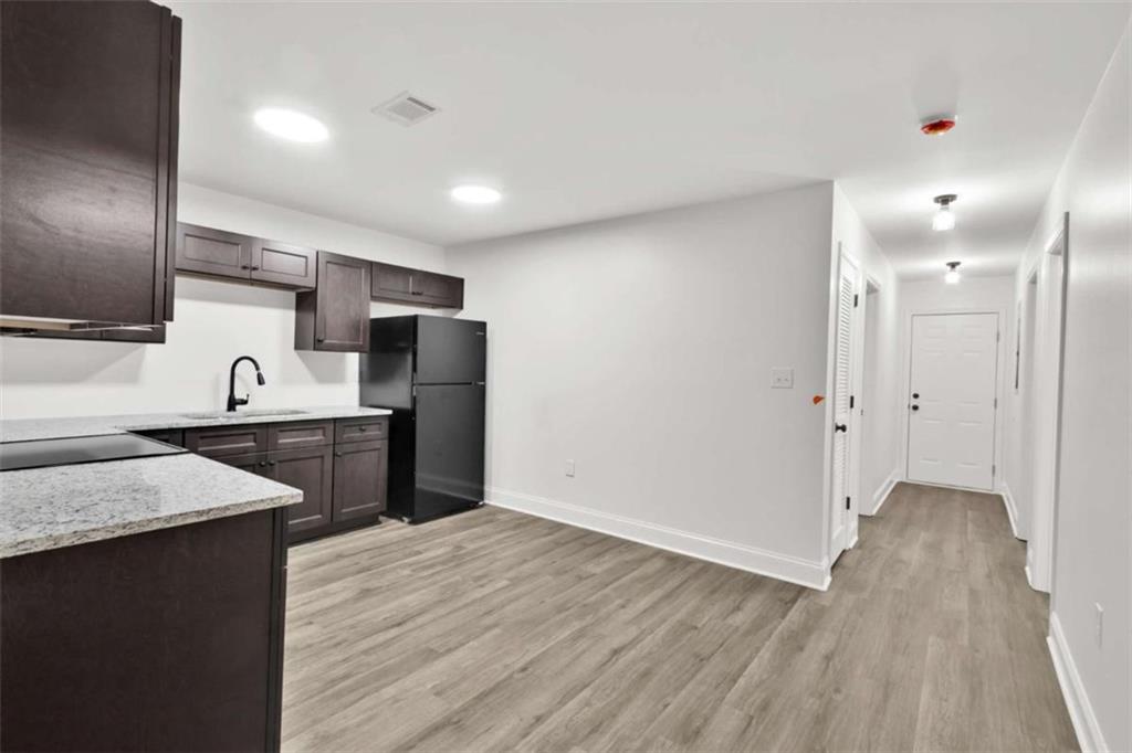 612 Elberta Street Fort Valley, GA 31030 - Photo 21 of 31 a kitchen with granite countertop a refrigerator and a sink