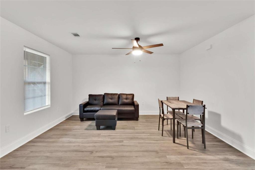 612 Elberta Street Fort Valley, GA 31030 - Photo 22 of 31 a living room with furniture and wooden floor