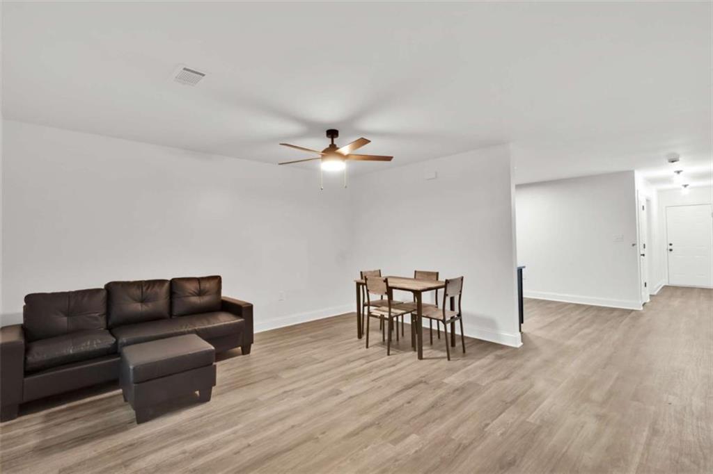 612 Elberta Street Fort Valley, GA 31030 - Photo 24 of 31 a living room with furniture and a wooden floor