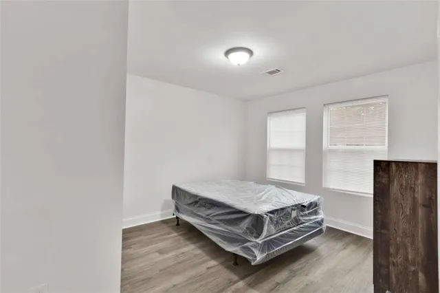 a bedroom with a bed and window