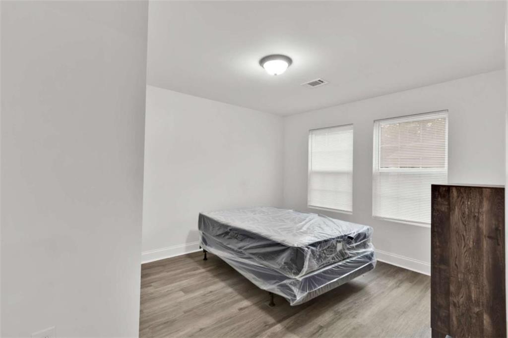 612 Elberta Street Fort Valley, GA 31030 - Photo 26 of 31 a bedroom with a bed and window