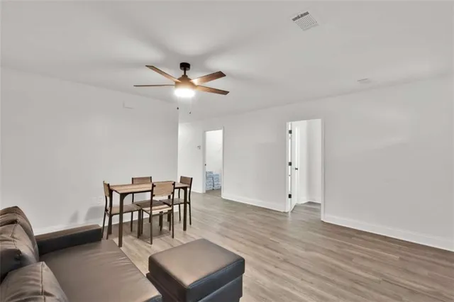 a view of a livingroom with furniture and wooden floor