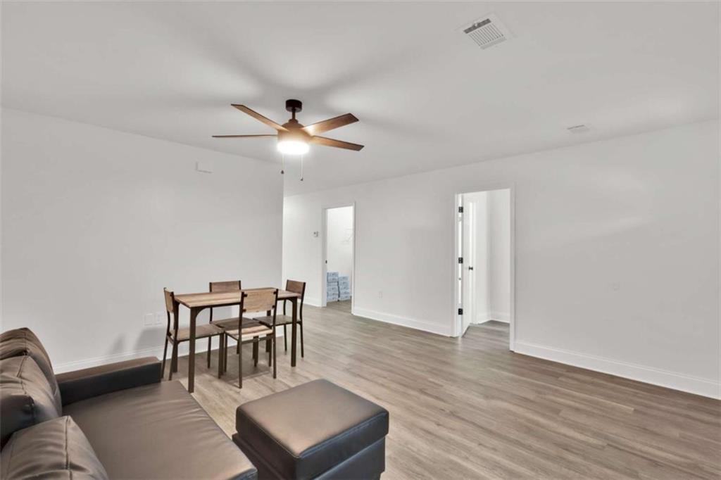 612 Elberta Street Fort Valley, GA 31030 - Photo 27 of 31 a view of a livingroom with furniture and wooden floor