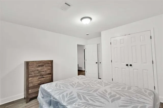 a bedroom with a bed and a closet