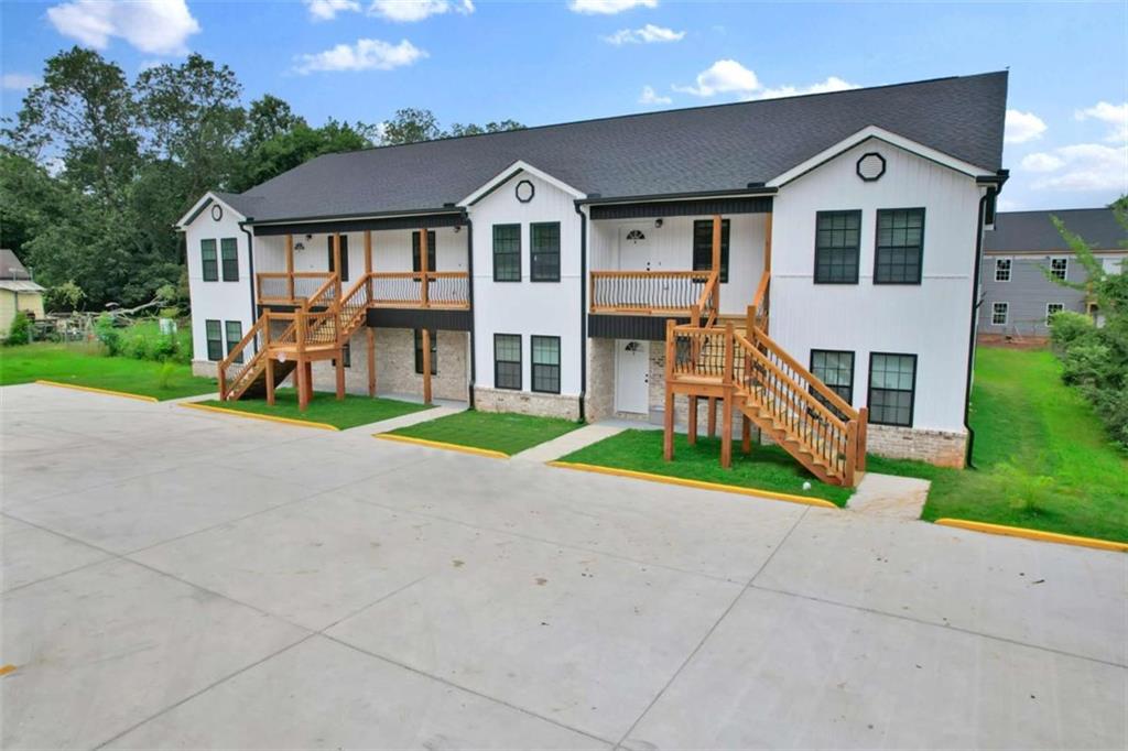 612 Elberta Street Fort Valley, GA 31030 - Photo 3 of 31 a front view of a house with a yard and garage