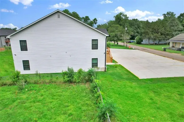 a view of a backyard with plants and a garden