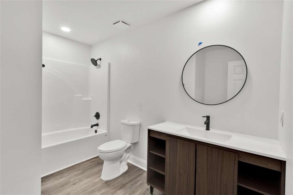 612 Elberta Street Fort Valley, GA 31030 - Photo 9 of 31 a bathroom with a sink a toilet and a mirror