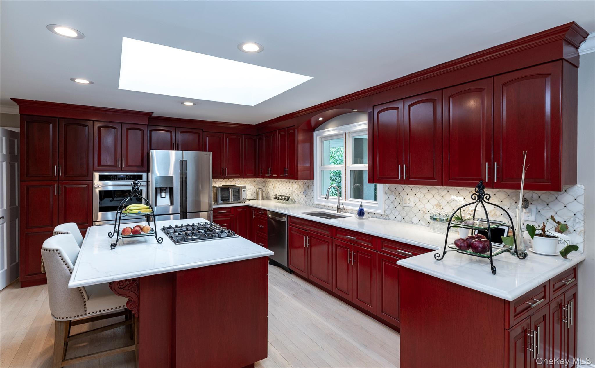 369 Phillips Hill Road New City, NY 10956 - Photo 11 of 40 Kitchen with dark brown cabinets, a skylight, ornamental molding, a kitchen island, and light countertops