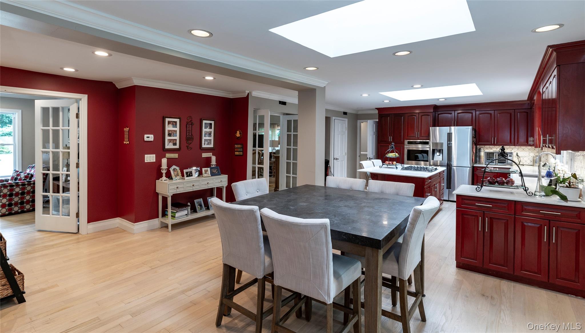 369 Phillips Hill Road New City, NY 10956 - Photo 12 of 40 Dining area featuring crown molding, a skylight, recessed lighting, light wood-type flooring, and french doors