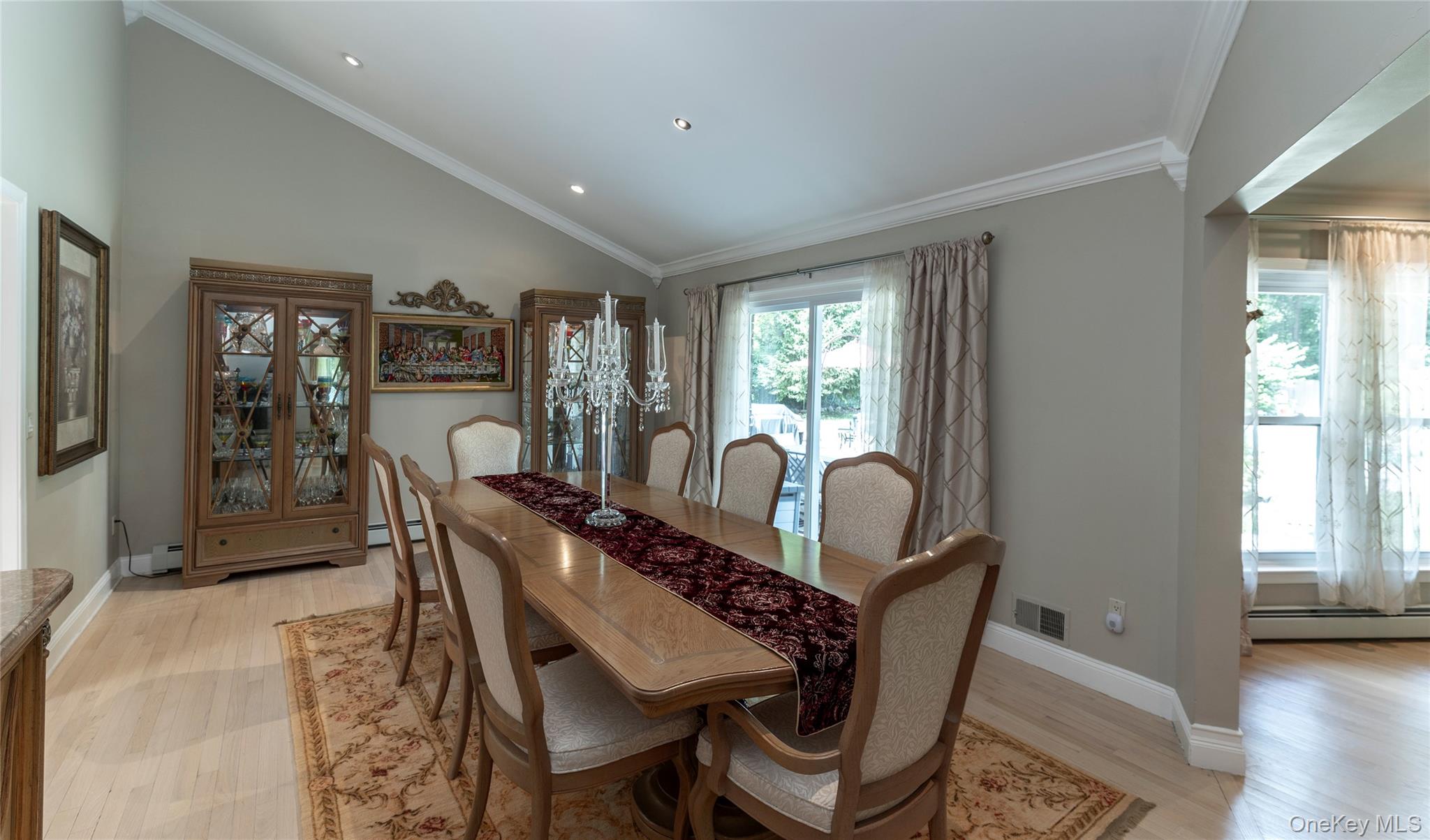 369 Phillips Hill Road New City, NY 10956 - Photo 17 of 40 Dining room featuring crown molding, light wood-style floors, baseboard heating, recessed lighting, and high vaulted ceiling