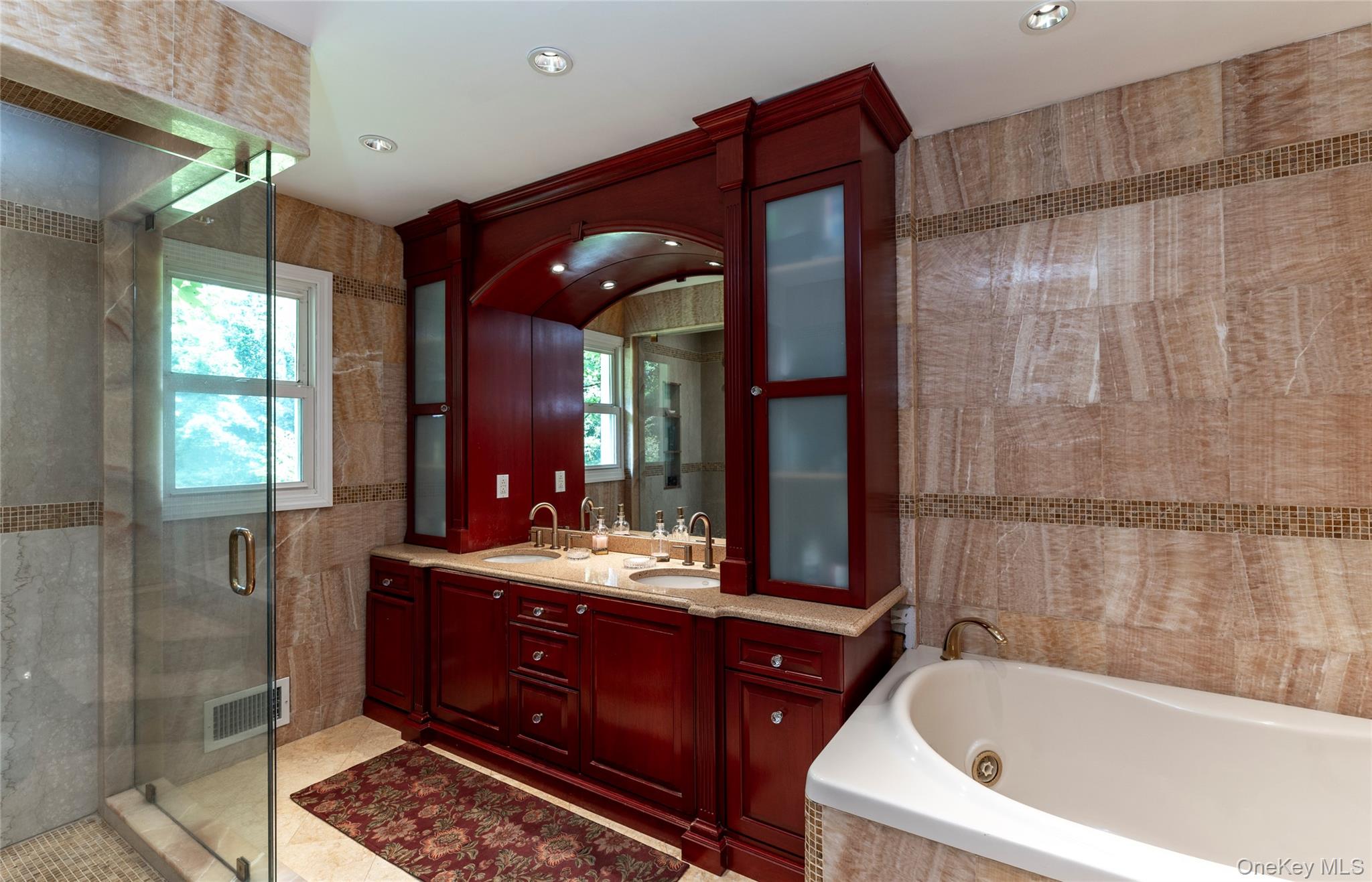 369 Phillips Hill Road New City, NY 10956 - Photo 24 of 40 Full bath featuring a jetted tub, a stall shower, tile walls, double vanity, and recessed lighting