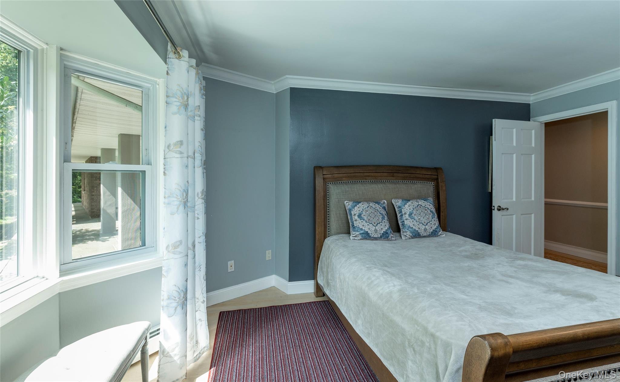 369 Phillips Hill Road New City, NY 10956 - Photo 27 of 40 Bedroom with multiple windows, crown molding, and wood finished floors