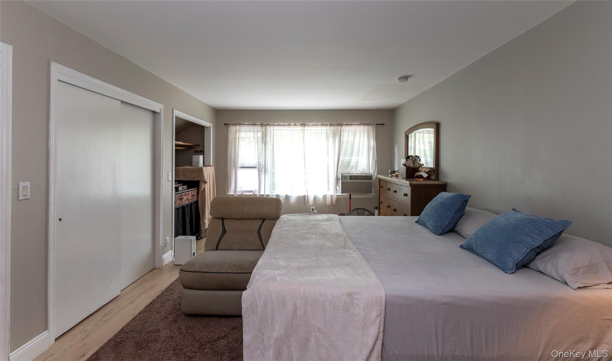 369 Phillips Hill Road New City, NY 10956 - Photo 30 of 40 Bedroom with multiple windows, light wood finished floors, and a fireplace