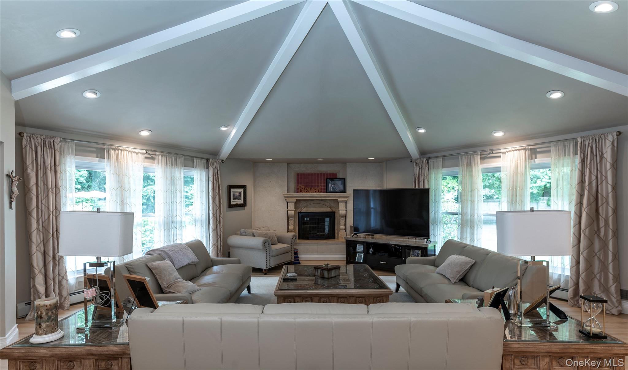 369 Phillips Hill Road New City, NY 10956 - Photo 8 of 40 Living area with healthy amount of natural light, beam ceiling, recessed lighting, high vaulted ceiling, and wood finished floors