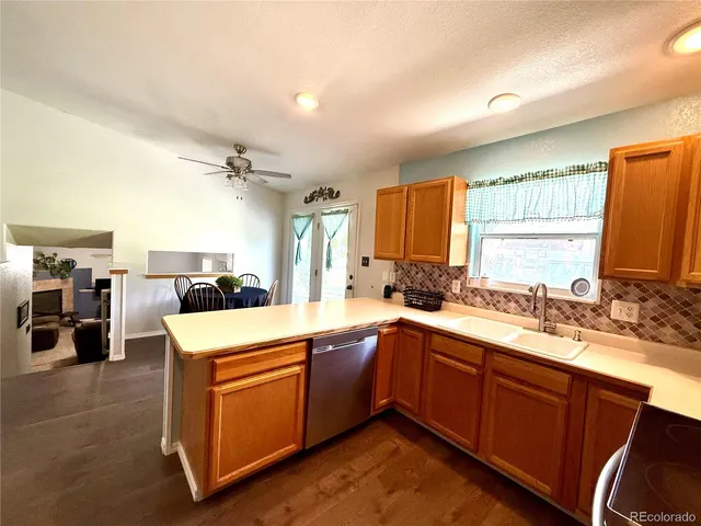 a kitchen with a sink a stove and cabinets