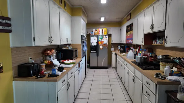 a kitchen with a sink a stove and cabinets