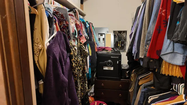 a view of walk in closet with clothes