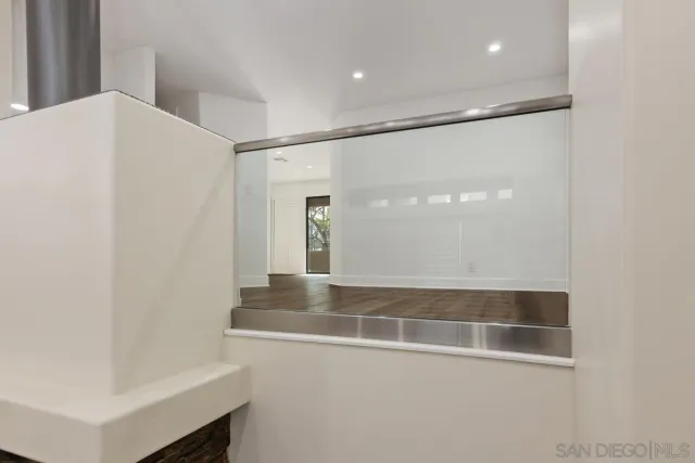 a view of a hallway with white walls