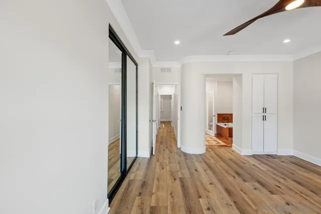 a view of a hallway with wooden floor