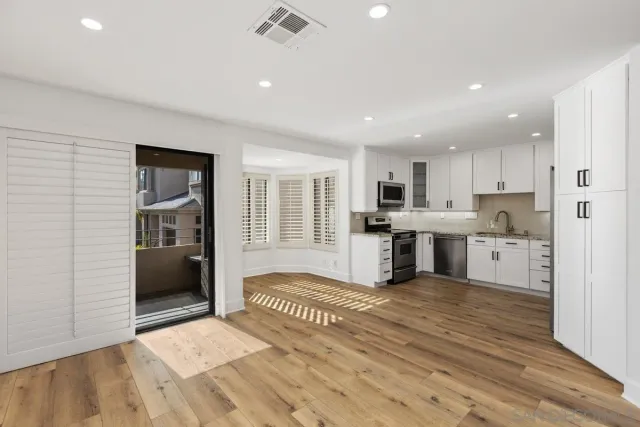 a kitchen with stainless steel appliances granite countertop a refrigerator and a sink