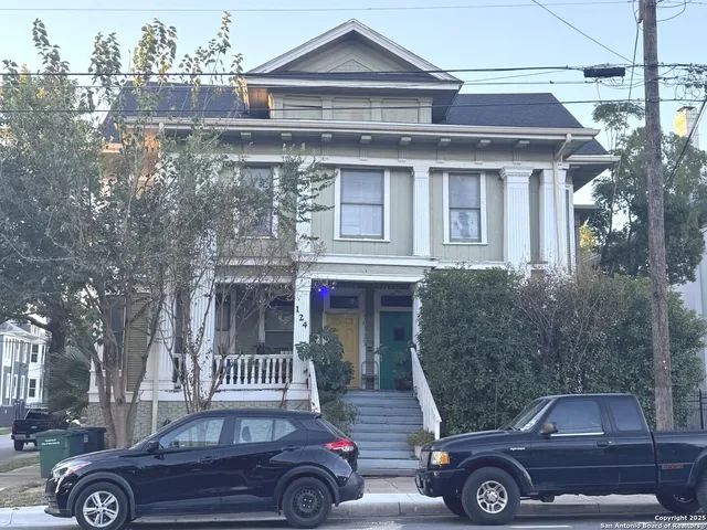 a front view of a house with parking space