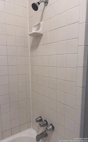 a white toilet sitting next to a white sink