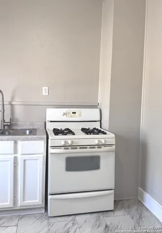 a stove top oven sitting inside of a kitchen