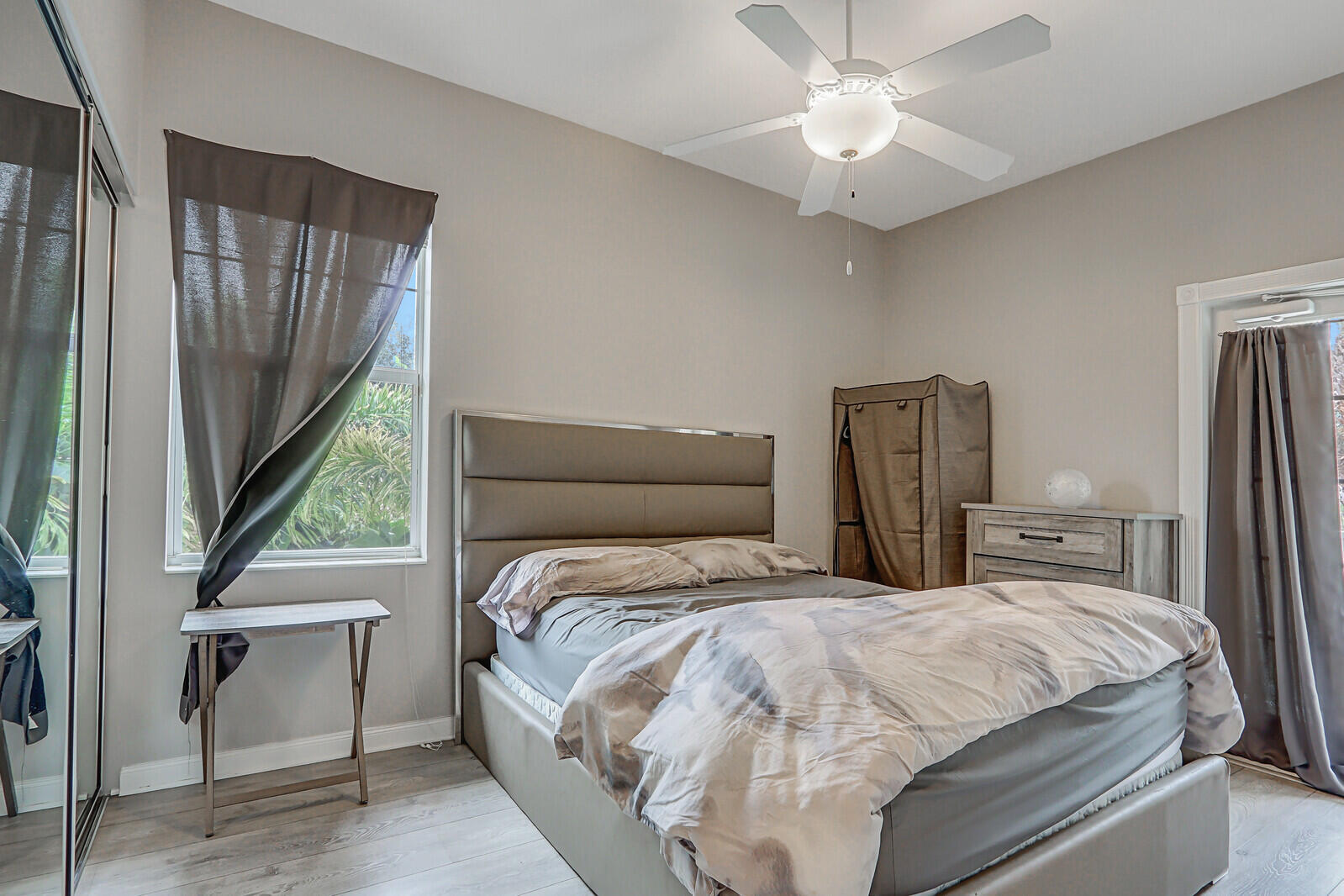 101 St Pierre Way Jupiter, FL 33458 - Photo 42 of 57 a bedroom with a large bed and a chandelier