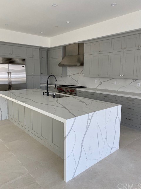 207 1st Street Seal Beach, CA 90740 - Photo 3 of 8 a kitchen with stainless steel appliances a sink a stove and cabinets