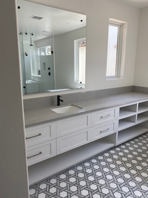 207 1st Street Seal Beach, CA 90740 - Photo 5 of 8 a bathroom with a sink vanity and mirror