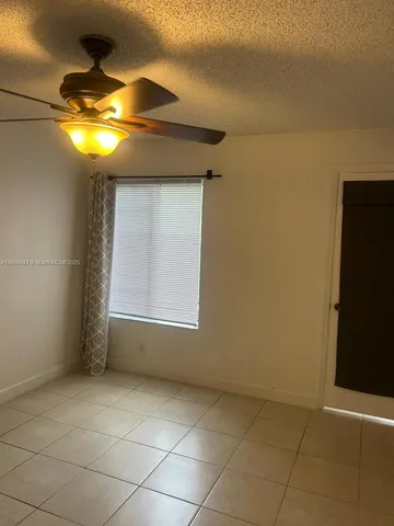 a view of room with a fireplace and chandelier
