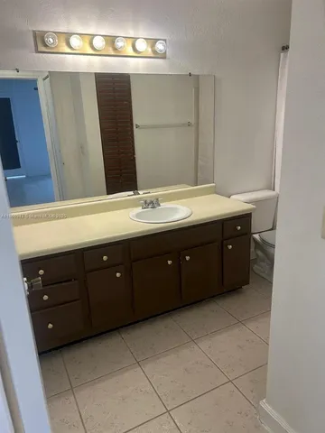 a spacious bathroom with a vanity and a mirror