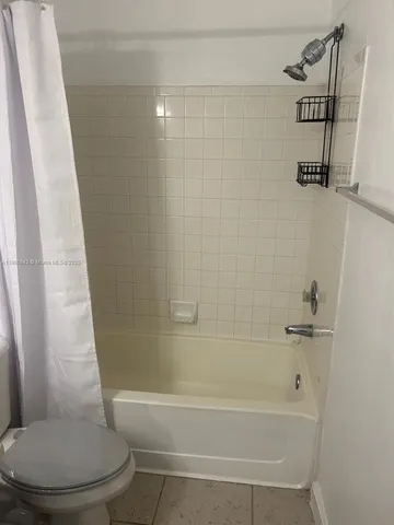 a bathroom with a bathtub and a toilet