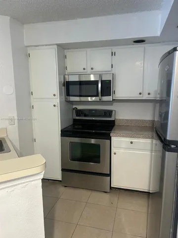 a kitchen with a stove and a microwave