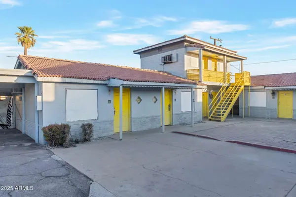 a front view of a house with plants