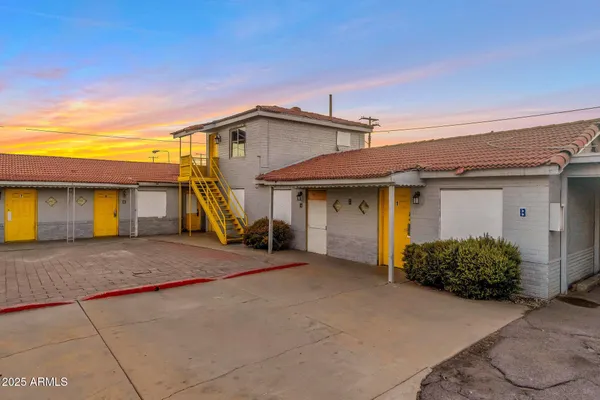 a view of a house with a patio and a yard