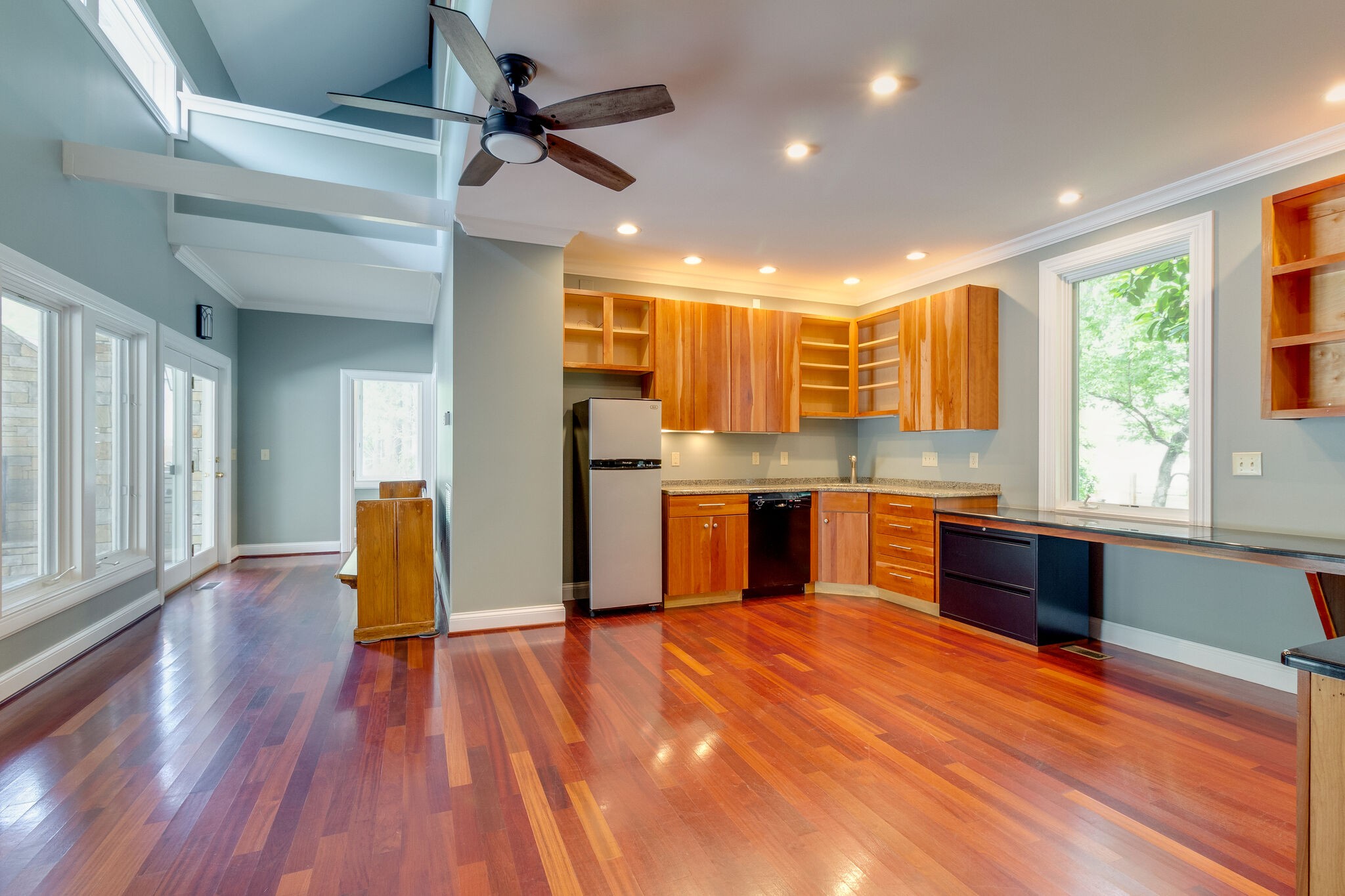 4036 Sneed Road Nashville, TN 37215 - Photo 19 of 24 a kitchen with stainless steel appliances kitchen island granite countertop wooden floors and view living room
