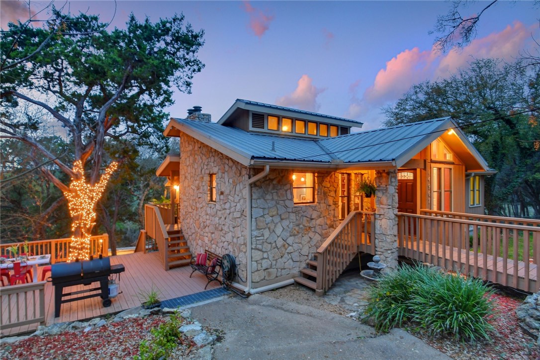 a backyard of a house with barbeque oven and outdoor seating